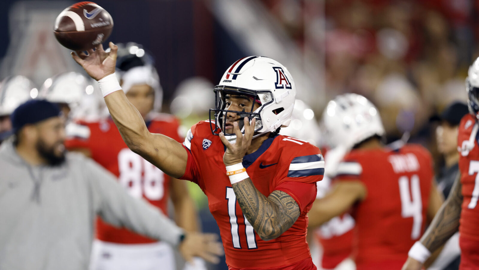 Arizona quarterback Noah Fifita warms up with a throw...