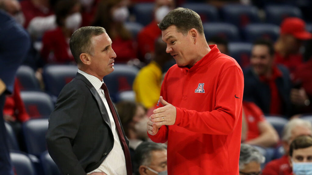 ASU's Bobby Hurley speaks with Arizona head coach Tommy Lloyd...