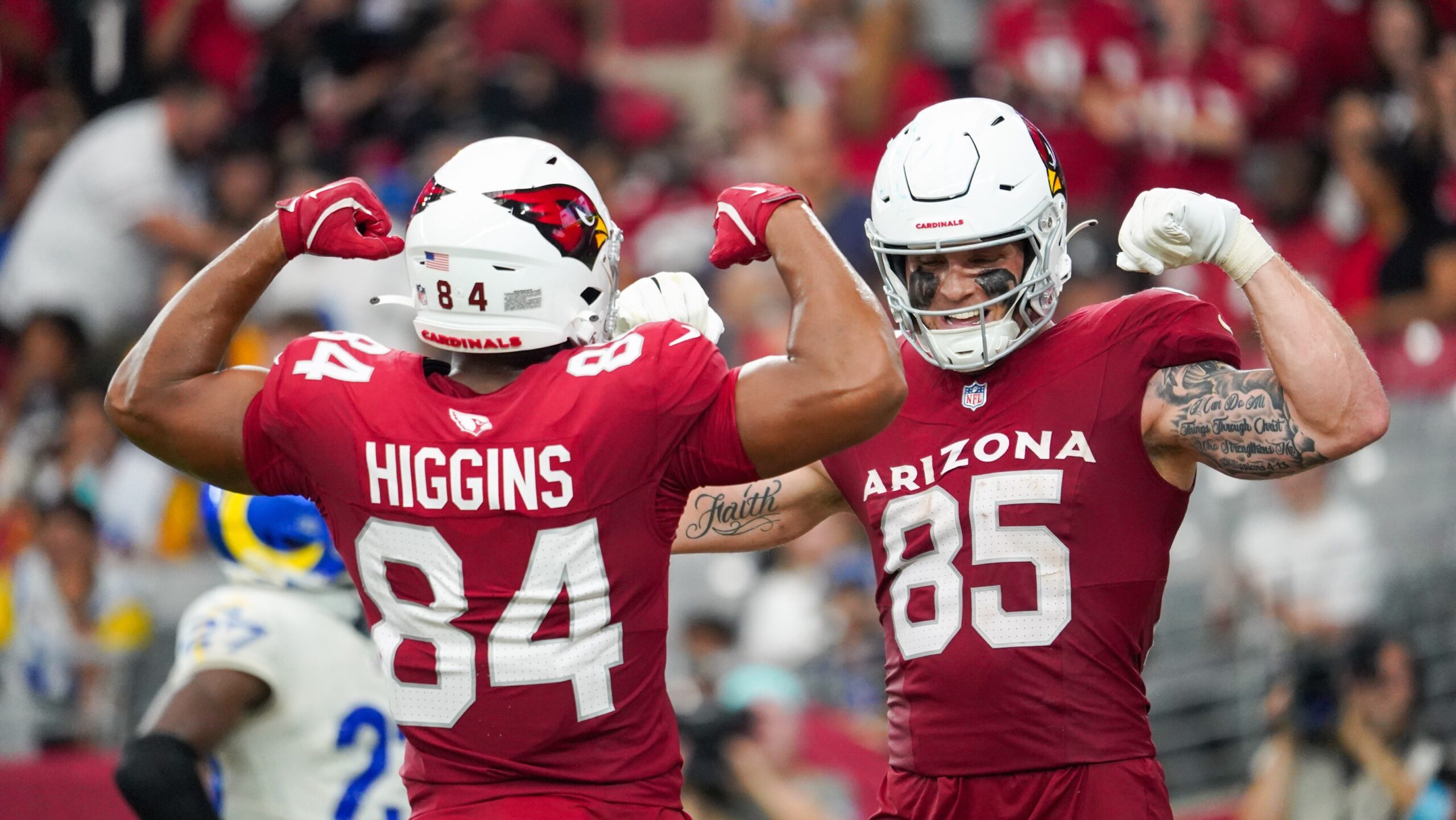 Cardinals TEs Trey McBride and Elijah Higgins celebrate during Week 2's win over the Rams...
