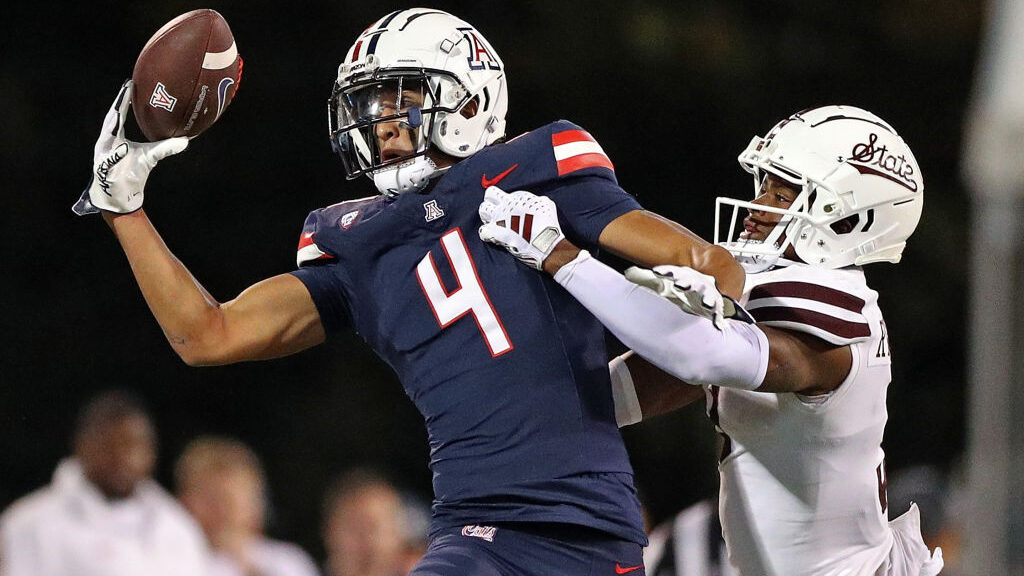 Tetairoa McMillan #4 of the Arizona Wildcats catches a pass against Decamerion Richardson #3 of the...