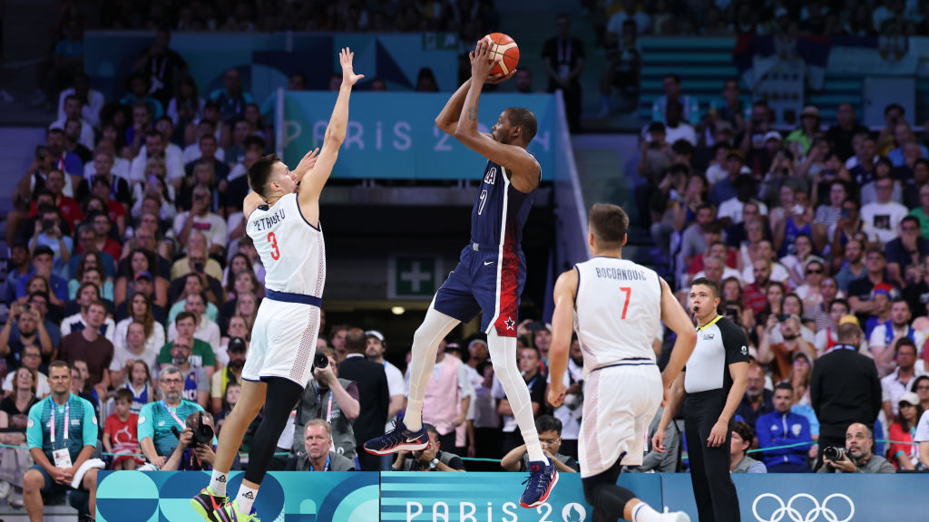 Kevin Durant #7 of Team United States shoots the ball against Filip Petrusev #3 of Team Serbia duri...