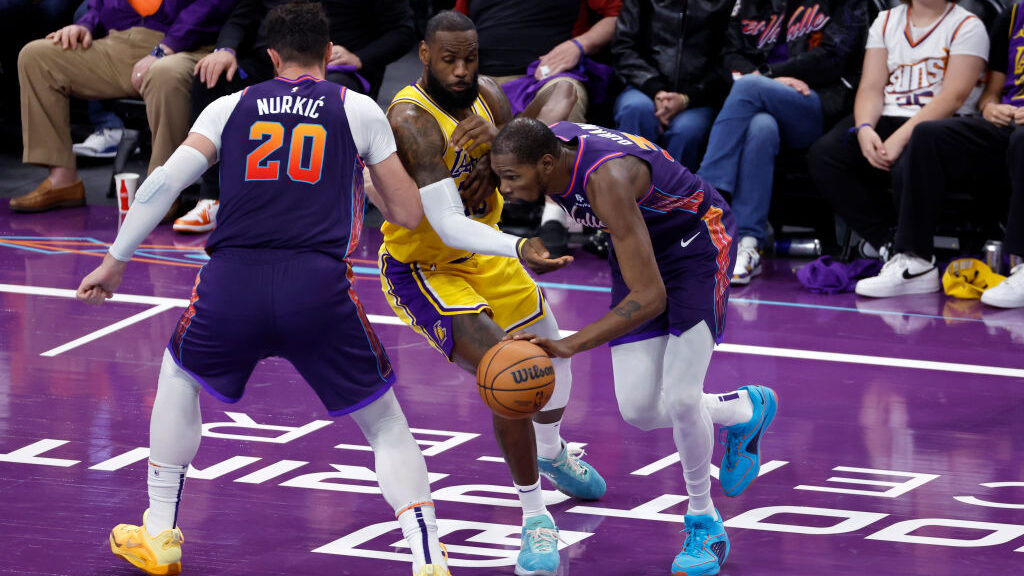 Kevin Durant #35 of the Phoenix Suns dribbles around a screen set by Jusuf Nurkic #20 on LeBron Jam...