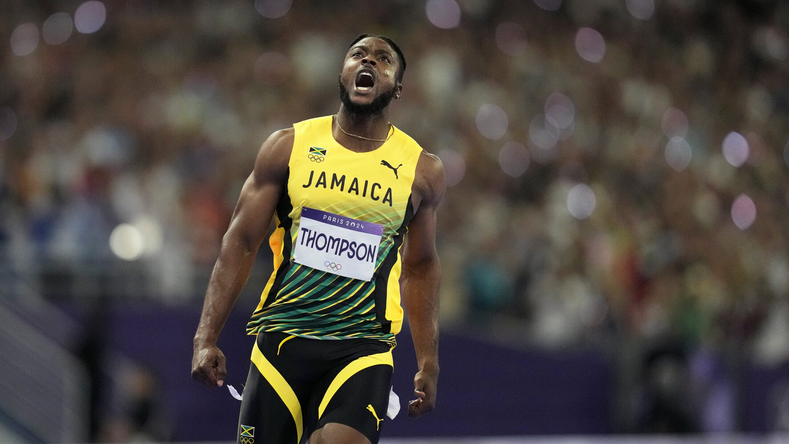 Kishane Thompson, of Jamaica, reacts after crossing the finish line in the men's 100 meters final a...