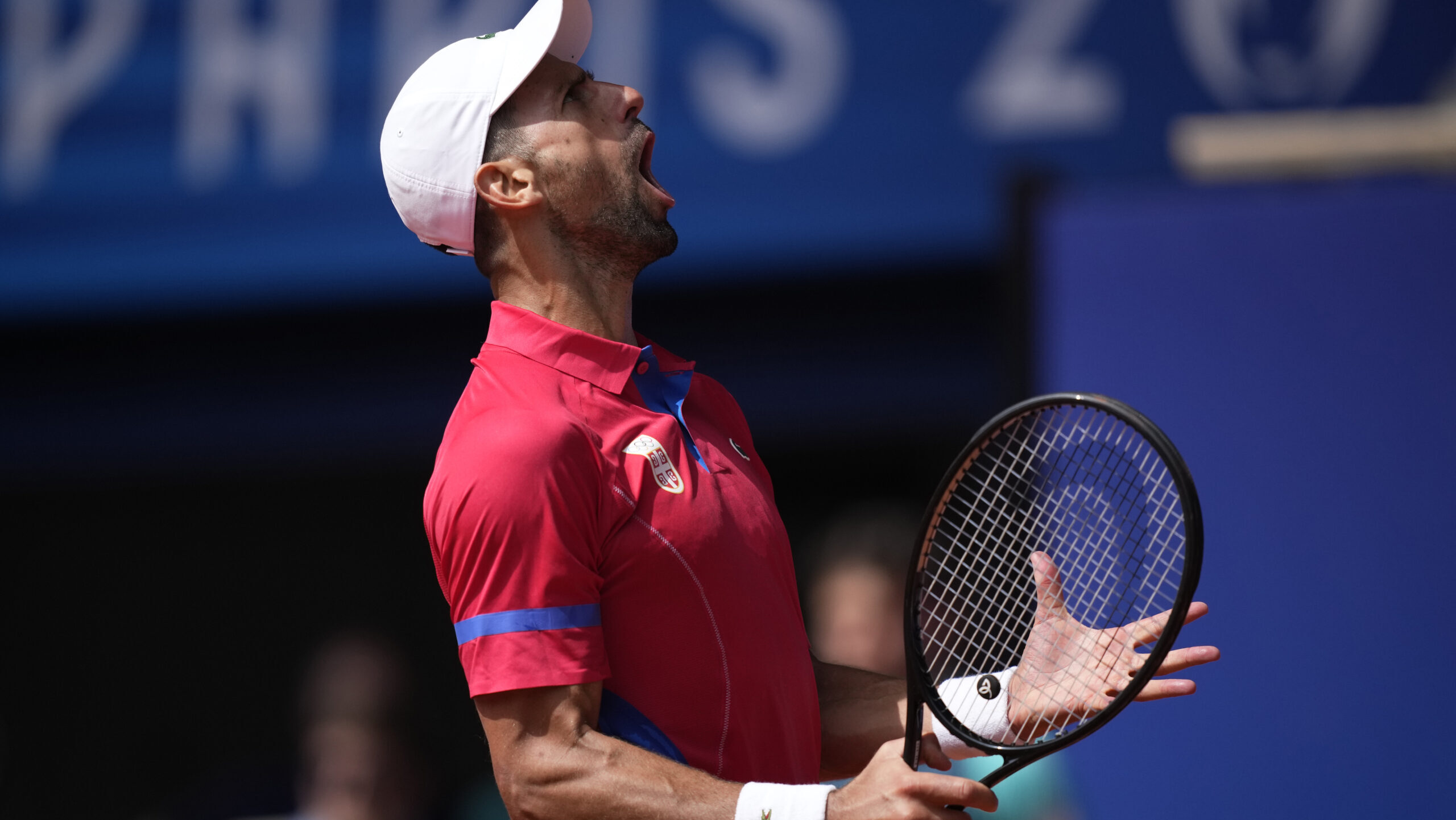Serbia's Novak Djokovic reacts after awinning a point against Spain's Carlos Alcaraz during the men...